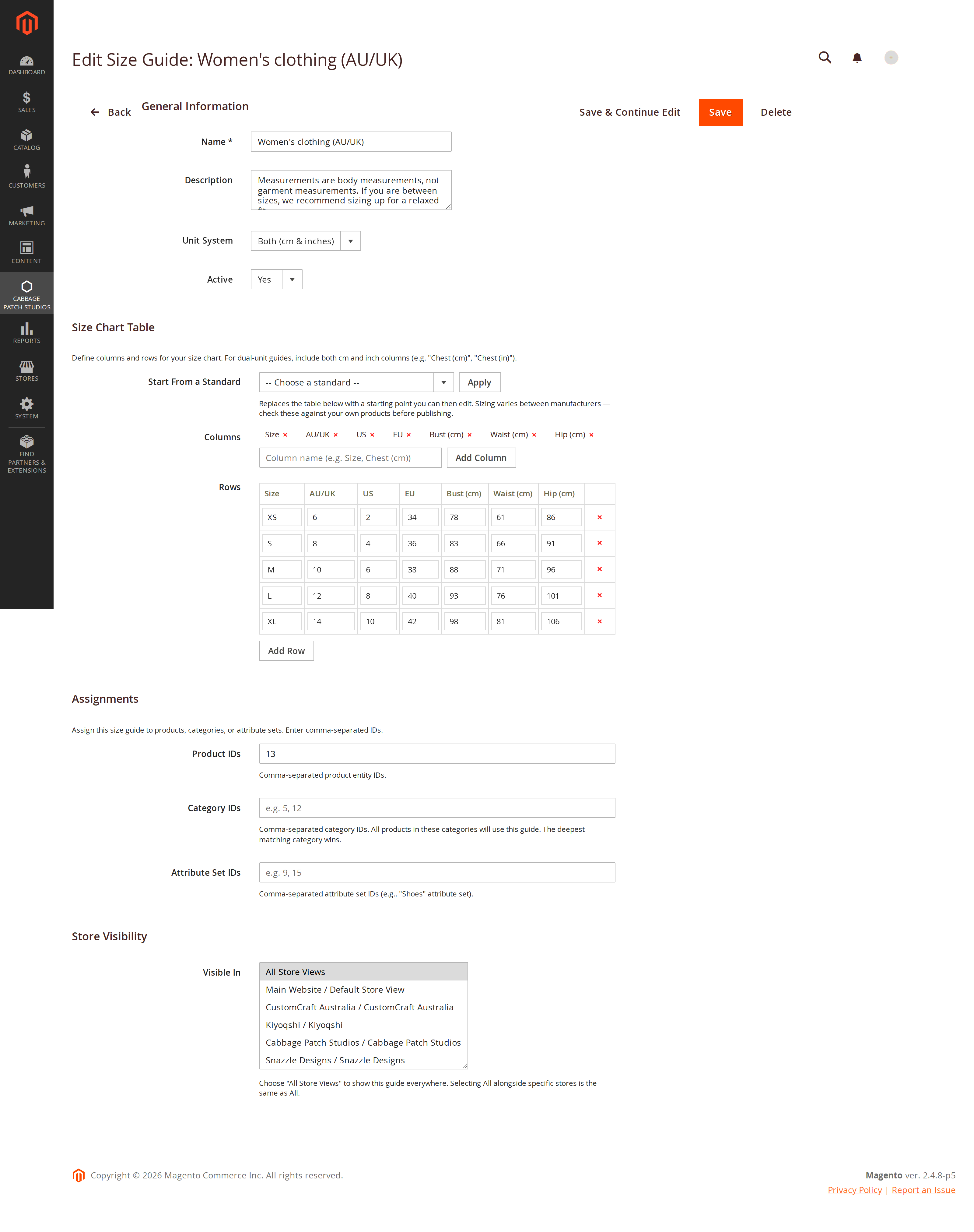 The Magento 2 admin size guide form, showing name, description, unit system, the size chart table, product, category and attribute-set assignment fields, and store visibility